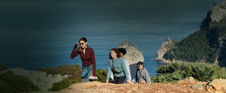 Actor portrayal of a group of women hiking in a scenic place