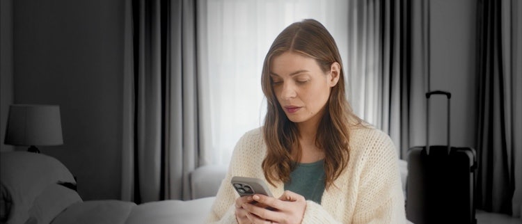 Actor portrayal of woman looking at her phone