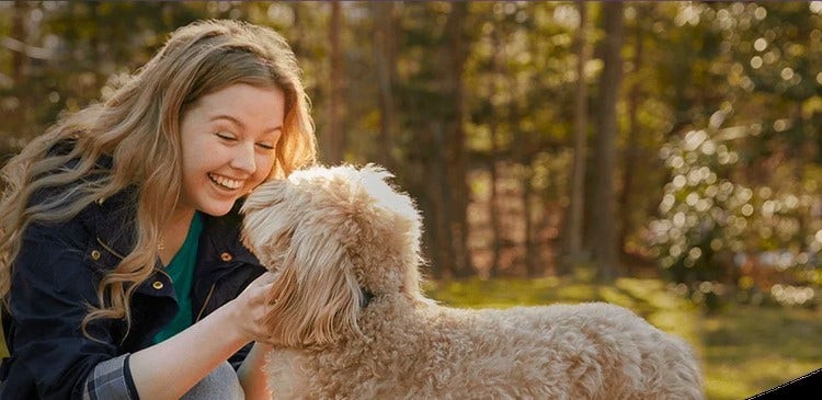 Actor portrayal of a woman petting a dog